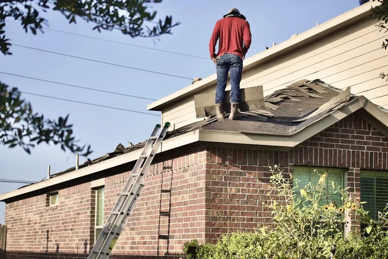 Professional roofer working on a residential roof in Hi-Vue Park